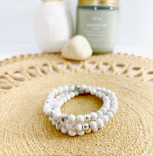White marbled beads called Howlite on stretch cord with one sterling silver bead.