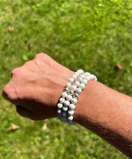 White marbled beads called Howlite on stretch cord with one sterling silver bead.