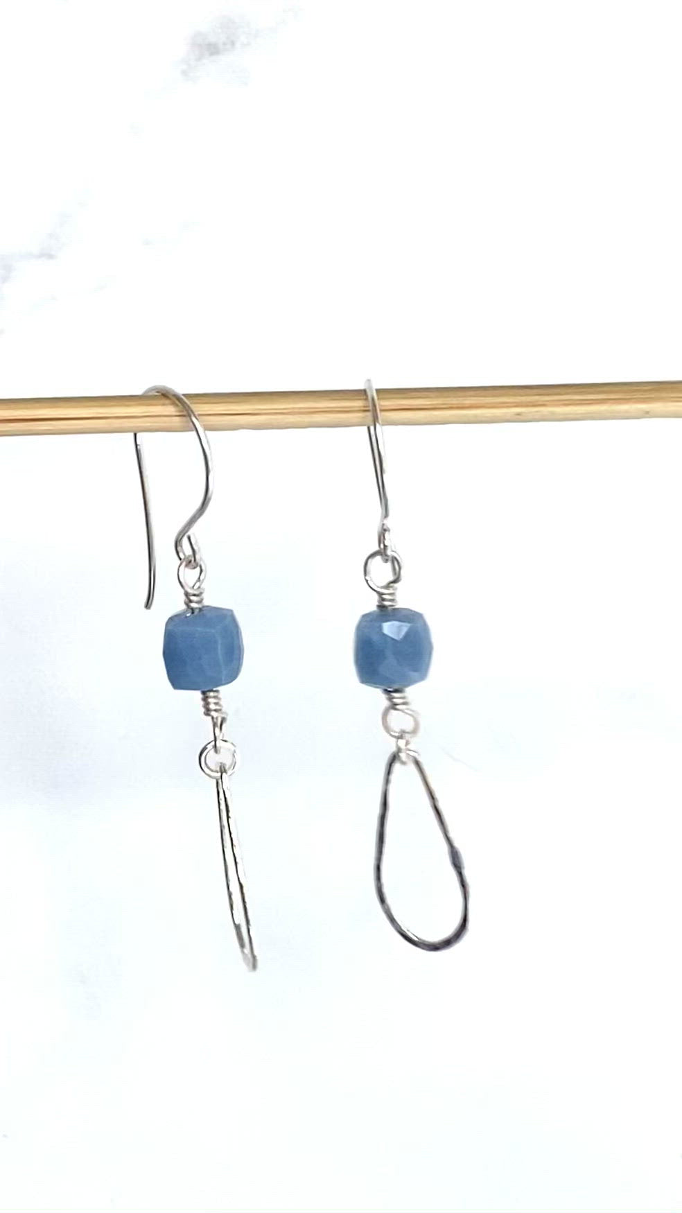 Load and play video in Gallery viewer, video of blue drops earrings dangling on wood dowel
