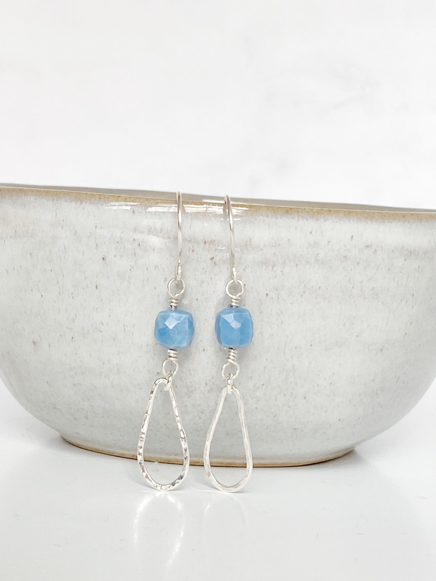 Blue Drops Earrings on grey ceramic bowl