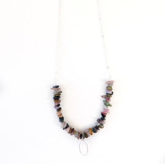 sterling necklace with multi colored tourmaline chips and a silver flat oval pendant in the middle