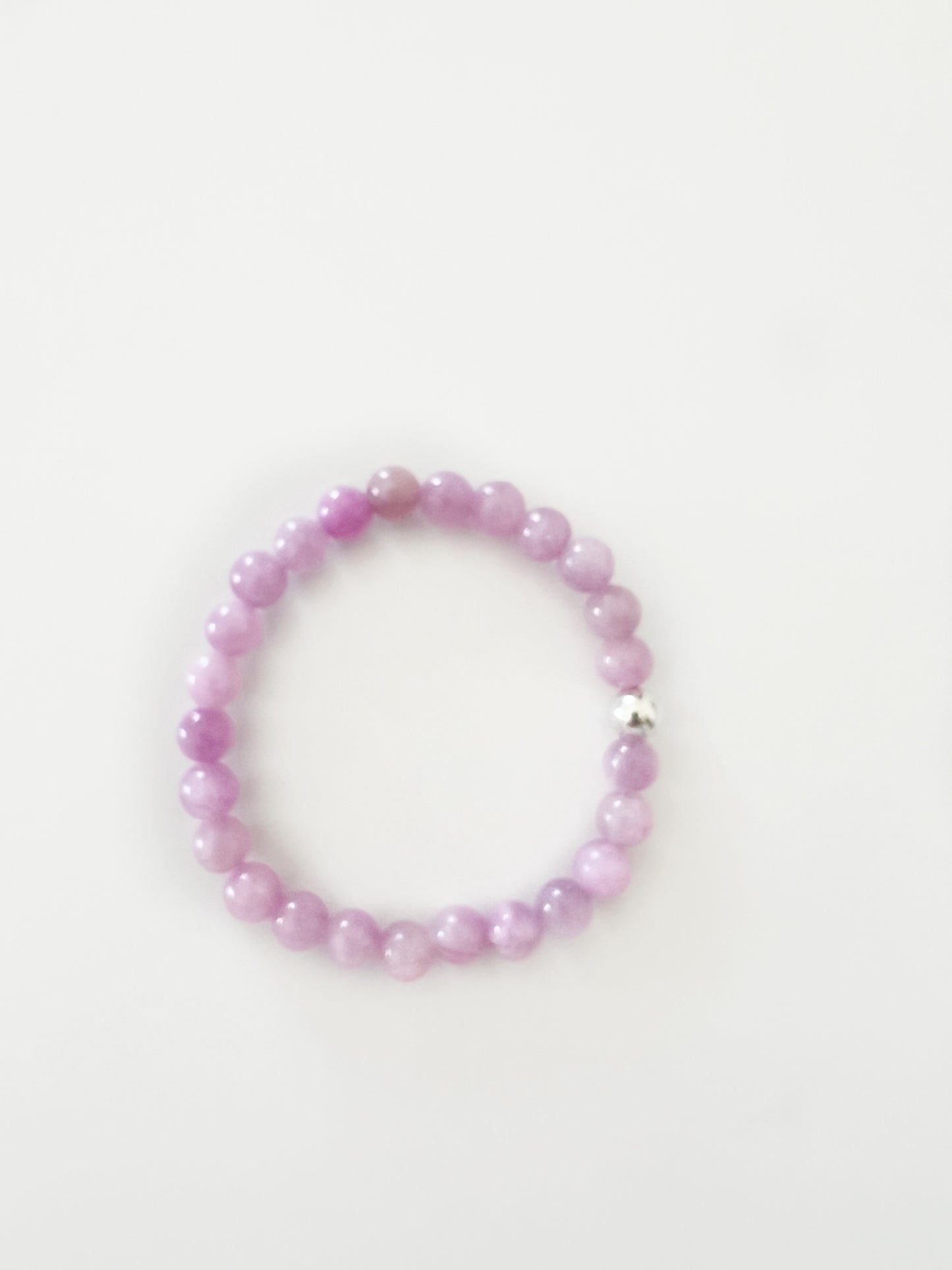 purple beaded stretch bracelet with one silver bead