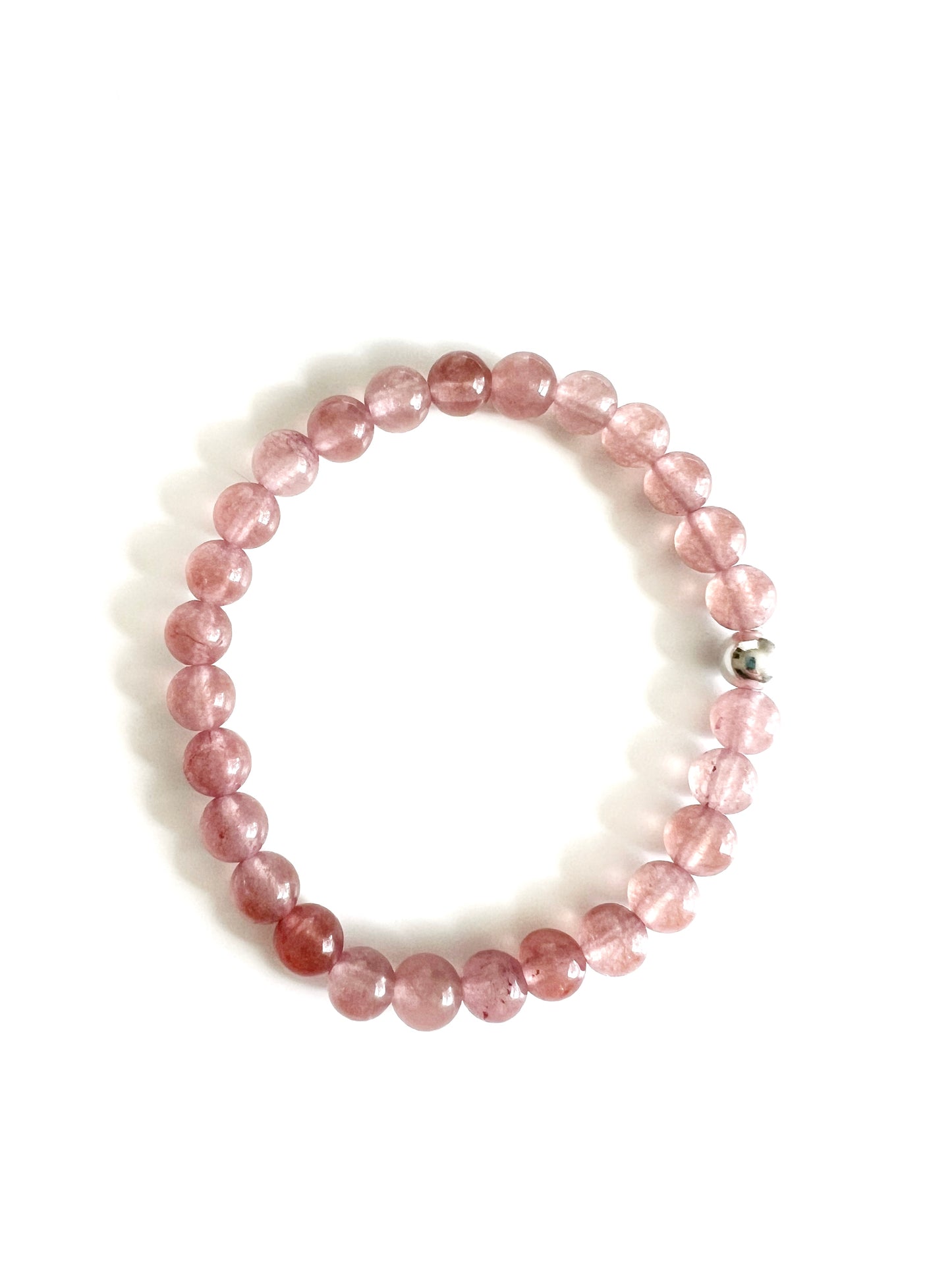 Strawberry Quartz stretch bracelet with one silver bead. Each bead is dark translucent pink