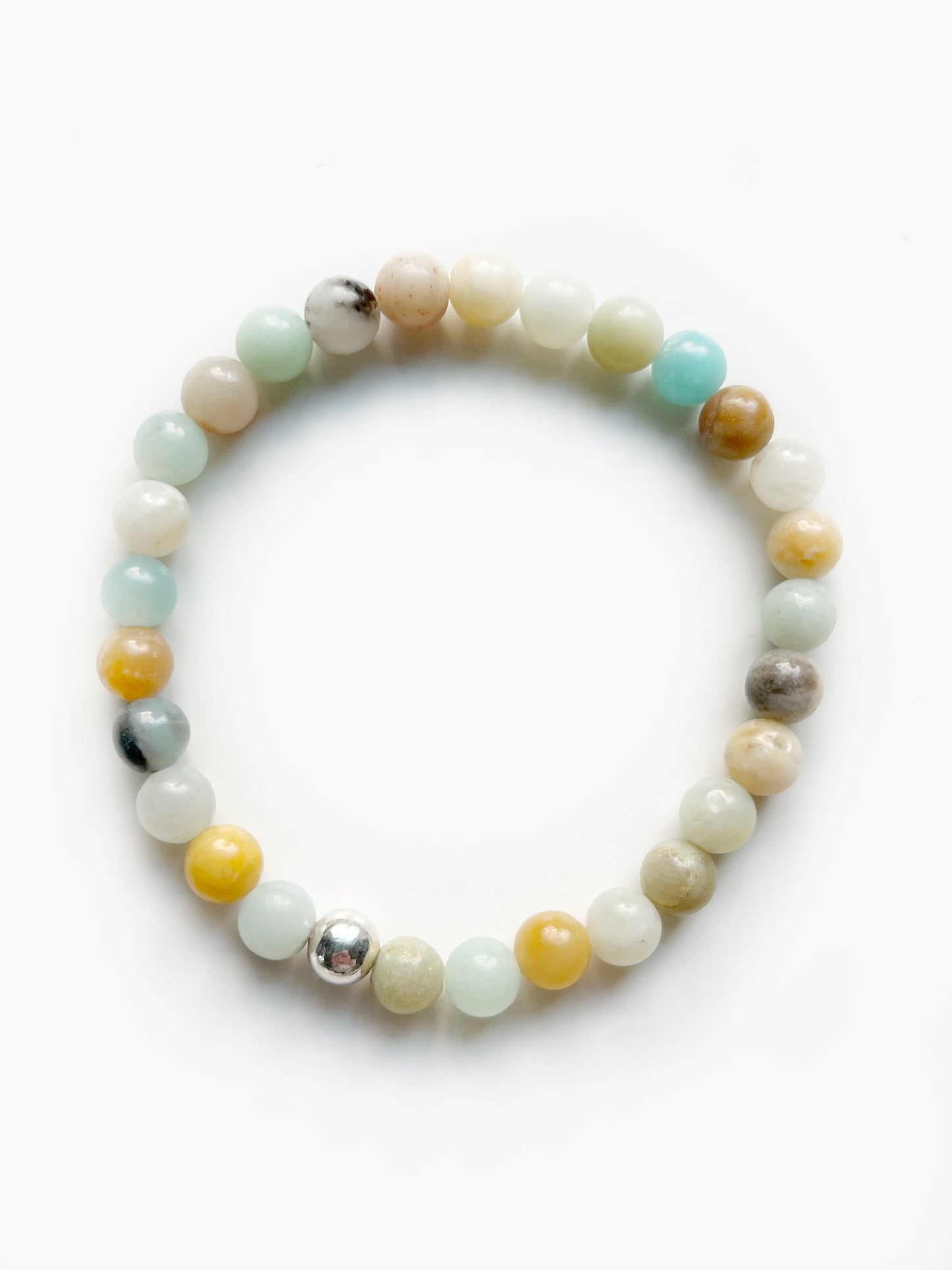 a multi colored stretch bracelet with light blue, yellow, black, white and orange beads. And one silver bead