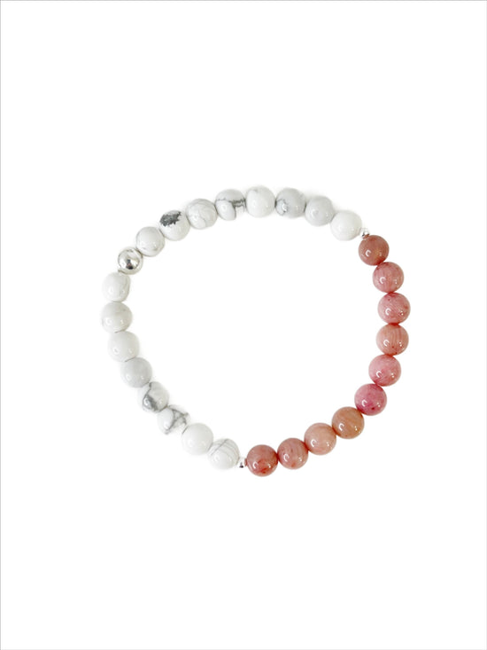 Simple everyday Howlite and Rhodonite stretch bracelet with one Sterling Silver bead on a white background.