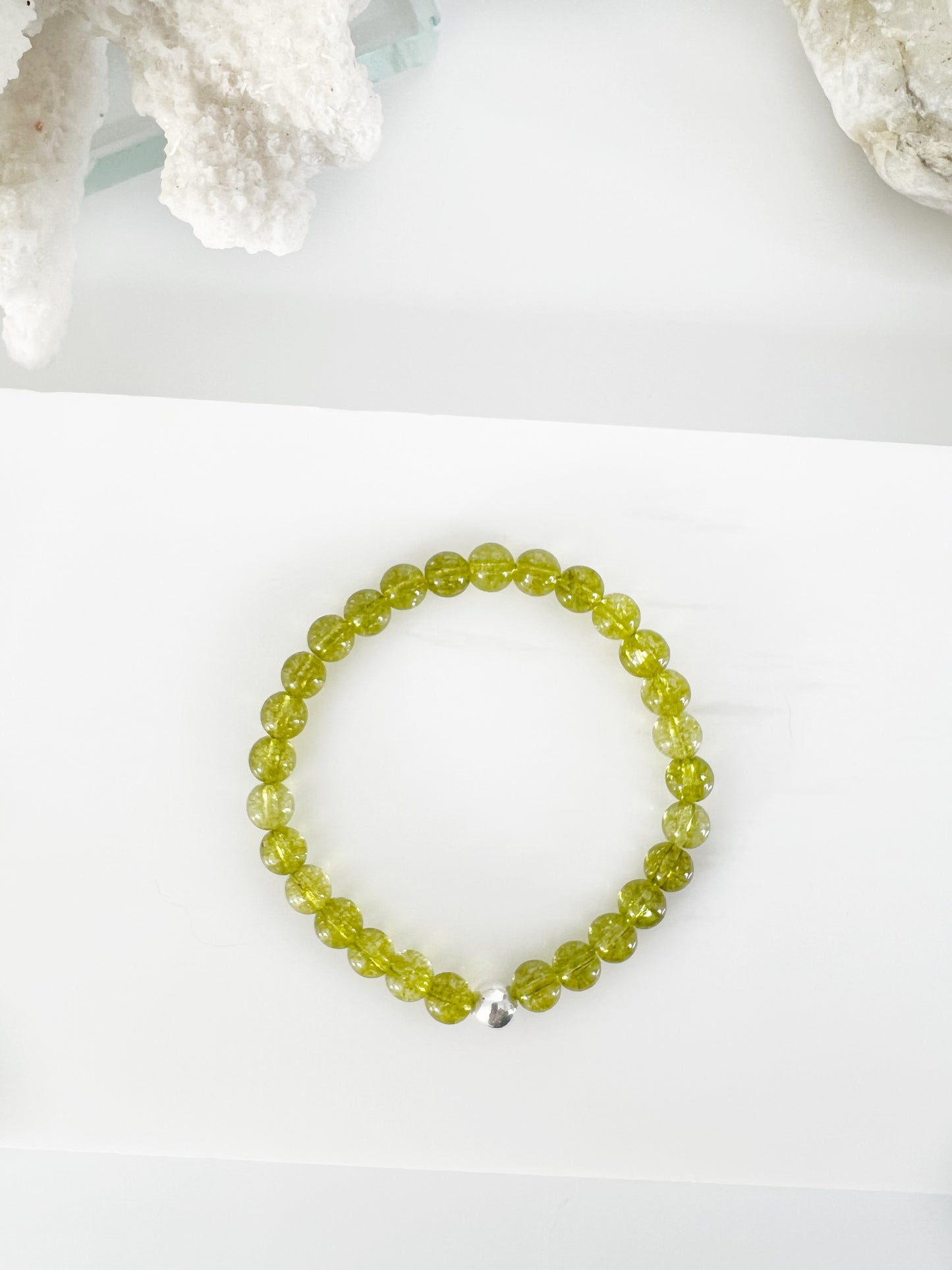 Simple everyday style peridot stretch bracelet with one sterling silver bead