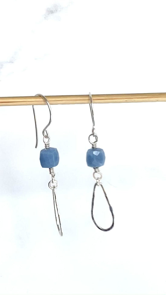 Load and play video in Gallery viewer, video of blue drops earrings dangling on wood dowel
