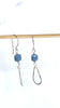 video of blue drops earrings dangling on wood dowel