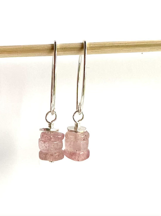 Load and play video in Gallery viewer, video of strawberry quartz earrings dangling from a small dowel
