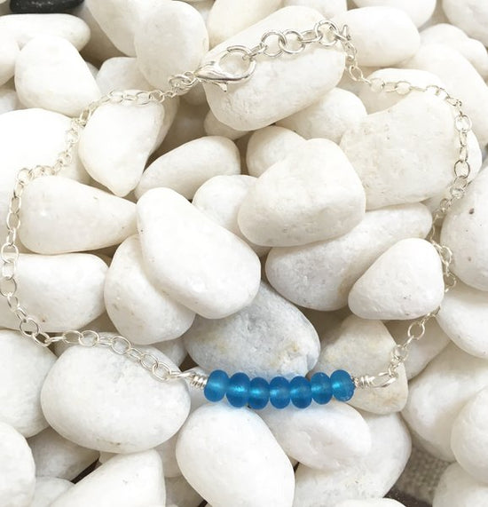 Load image into Gallery viewer, Ocean blue glass beads wire wrapped onto a sterling silver anklet
