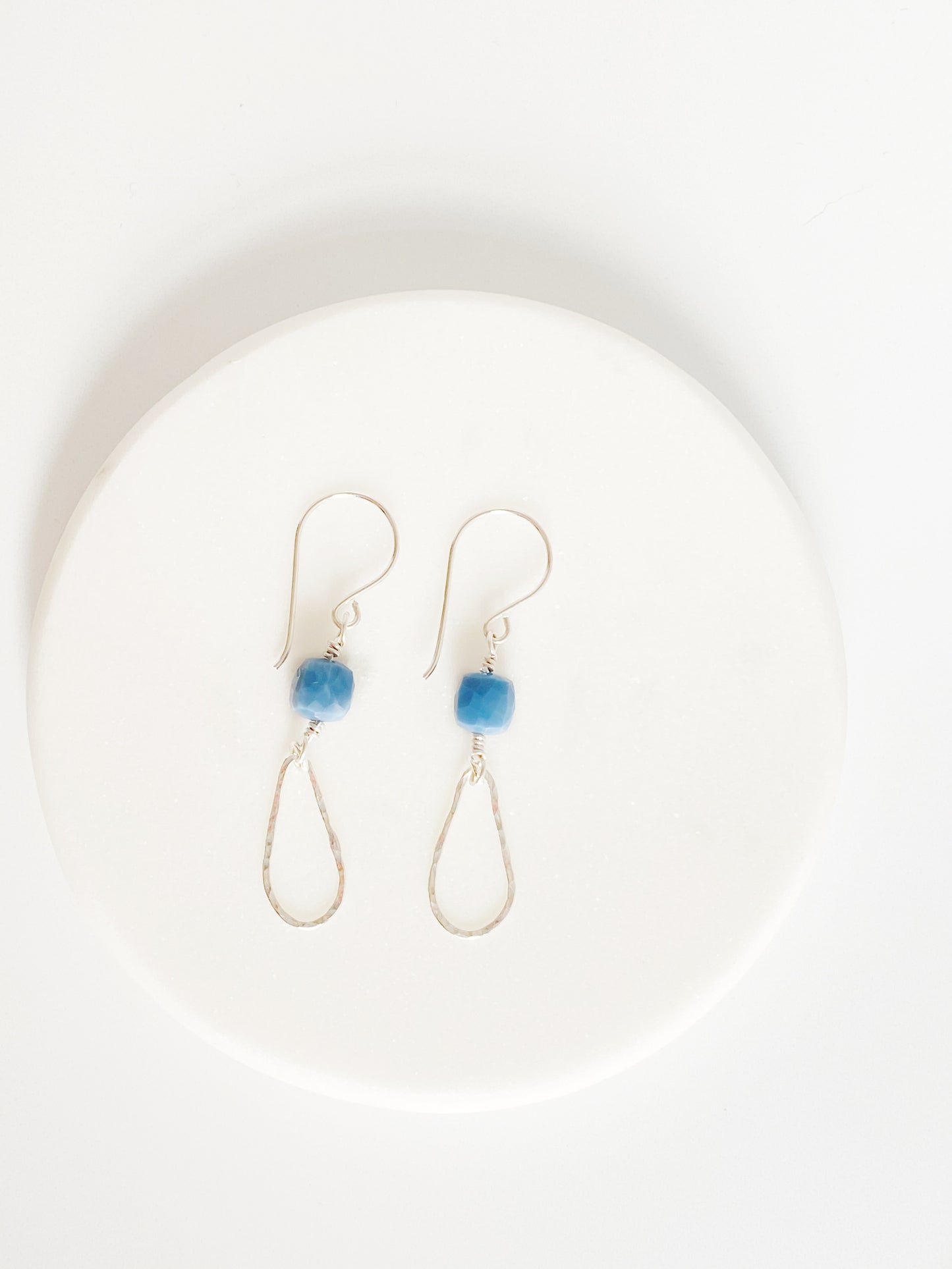 Blue Drops Earrings on white ceramic coaster
